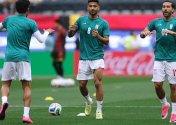 Mohammad Mohebi #8 of Iran warms up between Saman Ghoddos #14 and Ramin Rezaeian #23 Monday before the FIFA World Cup 2026 Group G match between Belgium and IR Iran at Los Angeles Stadium.