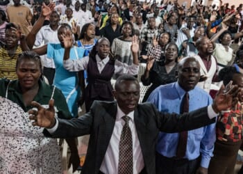 Christians worship and raise their hands at Victory church in Kampala, Uganda, on Jan. 11, 2026.