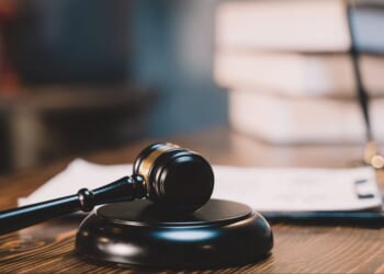 A gavel sits on top of a judge's desk.