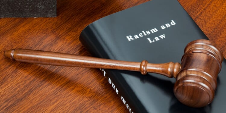 A gavel over a book tiled "Racism and Law."
