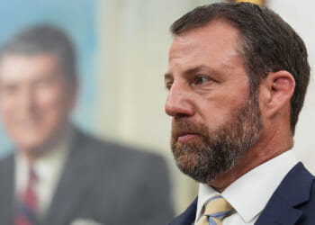 Marwayne Mullin looks on.