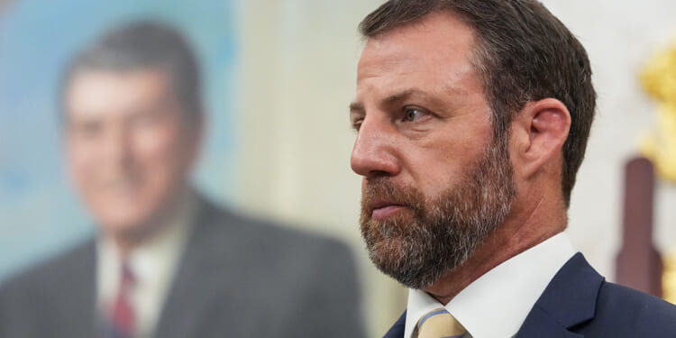 Marwayne Mullin looks on.