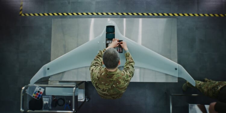 An engineer works on a drone.