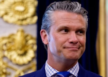 Secretary of War Pete Hegseth smiling