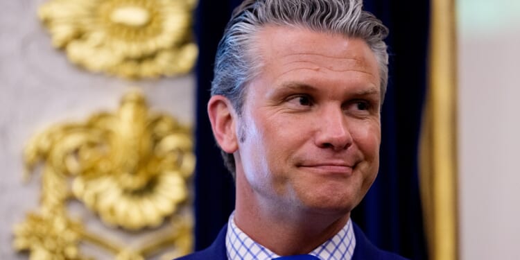 Secretary of War Pete Hegseth smiling