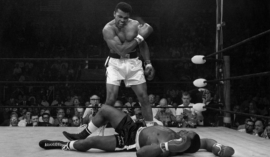 Heavyweight champion Muhammad Ali stands over fallen challenger Sonny Liston, shouting and gesturing shortly after dropping Liston with a short hard right to the jaw on May 25, 1965, in Lewiston, Maine. (AP Photo/John Rooney, file)