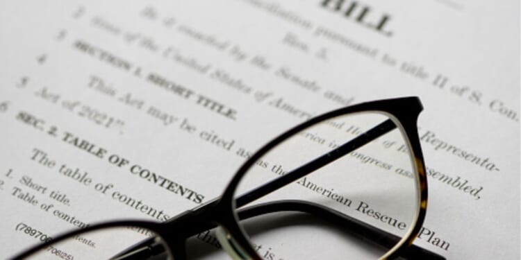 Glasses sit on a piece of legislation.