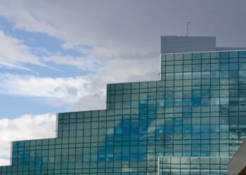 The glass architecture of the National Security Sciences Building at Los Alamos National Laboratory reflects the coming weather.