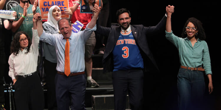 Socialist congressional candidate Claire Valdez, Congressional candidate Brad Lander, Mayor Zohran Mamdani, and Congressional candidate Darializa Avila Chevalier raise their hands during a Get Out the Vote (GOTV) rally at King's Theater on June 18, 2026 in New York City.