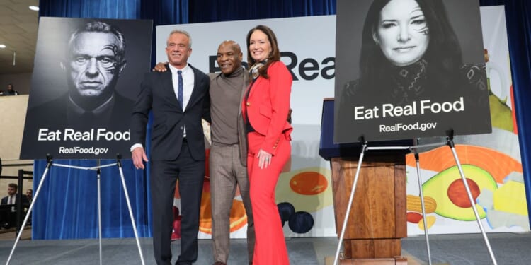 Secretary of Health and Human Services Robert F. Kennedy Jr., left, and Agriculture Secretary Brooke Rollins, right, were joined by former boxing heavyweight champion Mike Tyson, center, in February to roll out implementation of an "Eat Real Food" campaign.