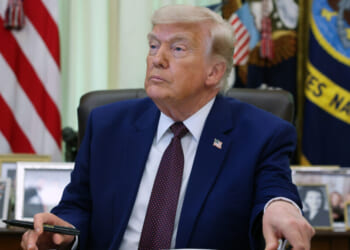 President Donald Trump prepares to sign an executive order during an event in the Oval Office of the White House on June 3 in Washington, DC. Trump signed executive orders related to strengthening customs enforcement and reforms to federal work laws. (Photo by Kevin Dietsch/Getty Images)