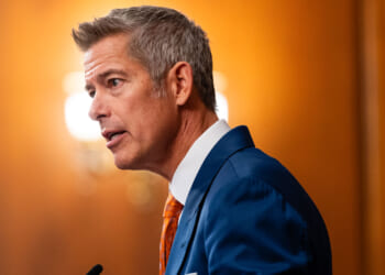 Side view of Transportation Secretary Sean Duffy as he speaks from the podium.
