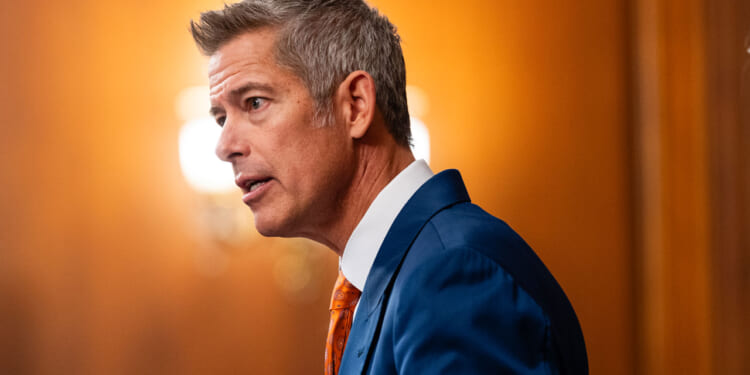 Side view of Transportation Secretary Sean Duffy as he speaks from the podium.