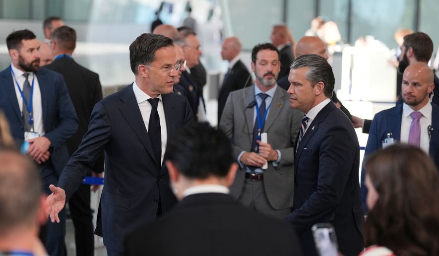 United States Defense Secretary Pete Hegseth, center right, and NATO Secretary General Mark Rutte, center left, arrive for a media conference during a meeting of NATO defense ministers at NATO headquarters in Brussels, Thursday, June 18, 2026. (AP Photo/Virginia Mayo)