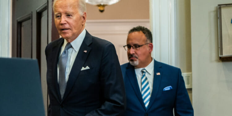 President Joe Biden and United States Secretary of Education Miguel Cardona enters for remarks on the Supreme Court's decision on the Administration's student debt relief program in the Roosevelt Room of the White House on Friday, June 30, 2023. (Photo by Demetrius Freeman/The Washington Post via Getty Images)