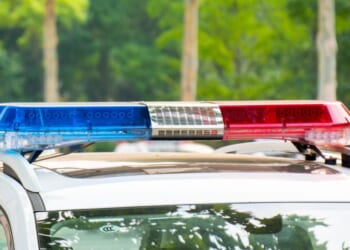Police lights on a car during traffic surveillance on the city road.