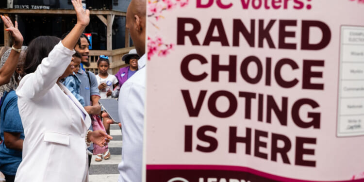 D.C. Ward 4 Council member Janeese Lewis George, candidate for D.C. mayor, waves to Ward 1 Council member Brianne Nadeau as she walks to Prince Hall Masonic Temple, a polling location, to vote in Washington, D.C. on Monday, June 8, 2026. Early voting has begun before D.C. primary election day on June 16. (Eric Lee for The Washington Post via Getty Images)