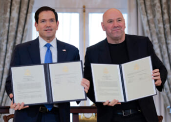 Secretary of State Marco Rubio (L) and Ultimate Fighting Championship CEO Dana White display a signed Memorandum of Understanding (MOU) during a ceremony at the U.S. State Department.