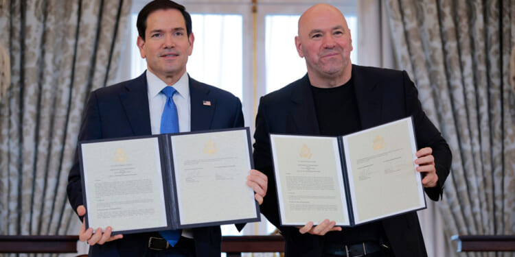 Secretary of State Marco Rubio (L) and Ultimate Fighting Championship CEO Dana White display a signed Memorandum of Understanding (MOU) during a ceremony at the U.S. State Department.