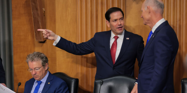 Marco Rubio is greeted by U.S. Sen. Rick Scott (R-FL) (R) as he arrives to testify during a Senate Foreign Relations Committee.