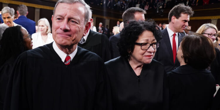 Supreme Court Chief Justice John Roberts and Associate Justice Sonia Sotomayor stand on the House floor ahead of the annual State of the Union address by U.S. President Joe Biden before a joint session of Congress at the Capital building on March 7, 2024 in Washington, DC. This is Biden's final address before the November general election. (Photo by Shawn Thew-Pool/Getty Images)