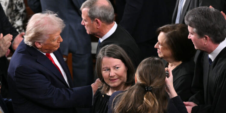 President Donald Trump shakes hands with Supreme Court Justice Elena Kagan (2R) as he arrives to deliver his State of the Union address in the House Chamber of the US Capitol in Washington, DC, on February 24, 2026. (Photo by Mandel NGAN / AFP via Getty Images)