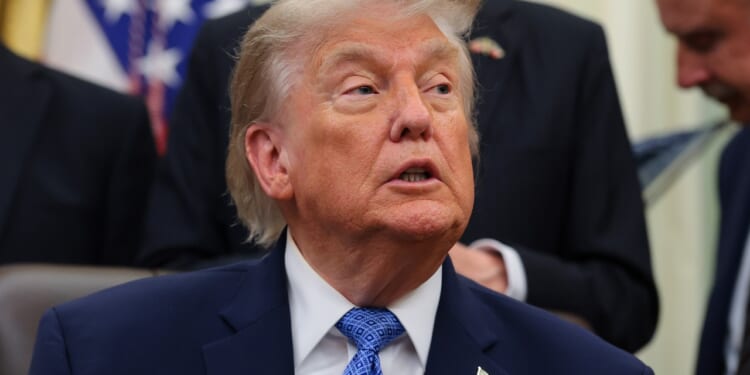 President Donald Trump seated