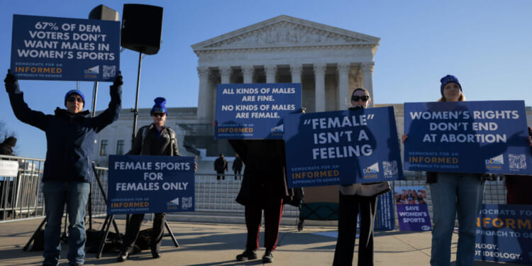 WASHINGTON, DC - JANUARY 13: Protesters who align with the Democratic Party but are against transgender athletes competing in women's sports gather outside the Supreme Court on January 13, 2026 in Washington, DC. Groups from both sides of the debate gathered on Tuesday morning to protest while two cases that prohibit transgender girls from joining girls' and women's sports teams are heard inside the Supreme Court. (Photo by Heather Diehl/Getty Images)