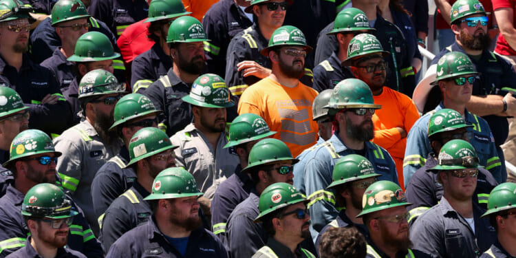 Workers listen as US Vice President JD Vance speaks, during a tour of Nucor Steel Berkeley in Huger, South Carolina, on May 1, 2025. (Photo by Kevin Lamarque / POOL / AFP) (Photo by KEVIN LAMARQUE/POOL/AFP via Getty Images)