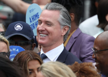 A smiling Gavin Newsom amid a group of people.