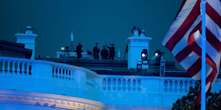 Secret Service agents are seen atop the White House during UFC Freedom 250 on the South Lawn on June 14, 2026, in Washington, D.C.