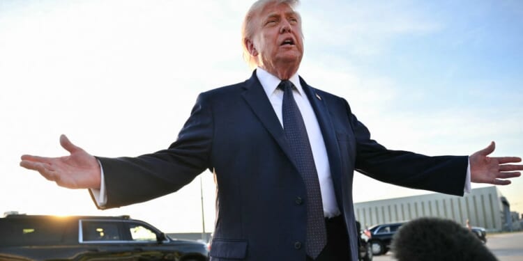 President Donald Trump gestures as he addresses the media on the tarmac after arriving at Paris Orly Airport en route to a dinner to celebrate the 250th anniversary of the independence of the United States, at Orly Airport, south of Paris, on June 17, 2026.