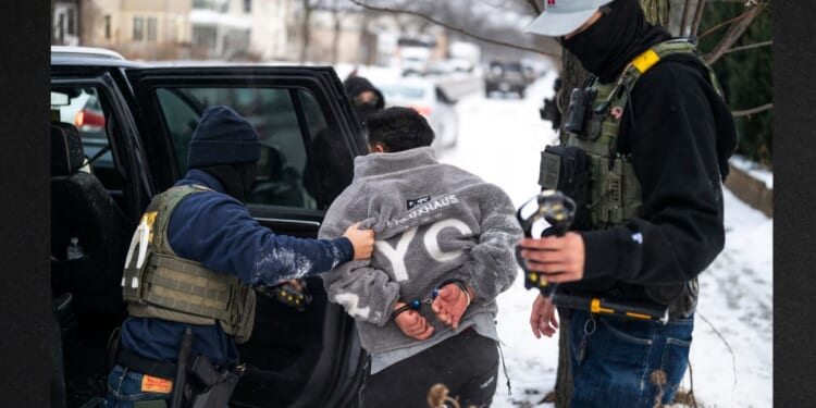 A man is detained by a Border Patrol agent in a file photo dated Jan. 21 in Minneapolis, Minnesota.