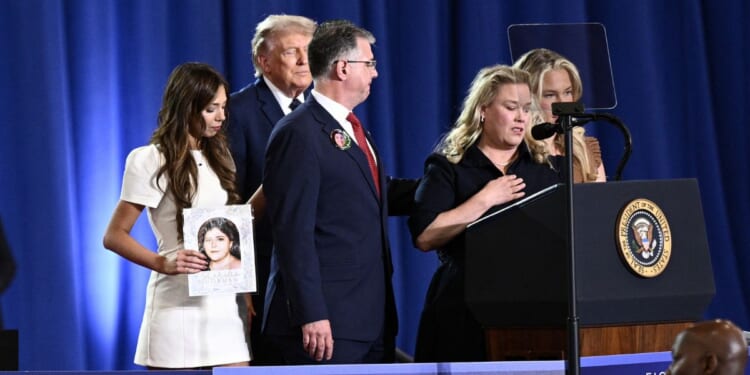 President Donald Trump listens as Jessica Gorman, mother of Sheridan Gorman, speaks during an event on the economy at Rockland Community College Fieldhouse in Suffern, New York, on May 22, 2026.