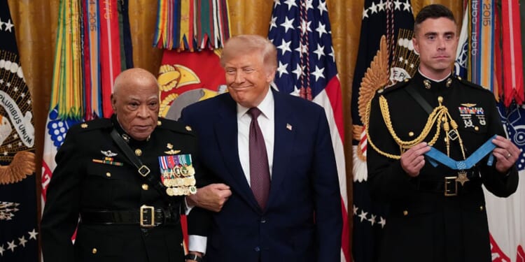 Retired Marine Maj. James Capers Jr. stands with President Donald Trump before he is presented the Medal of Honor Thursday at the White House in Washington, D.C.