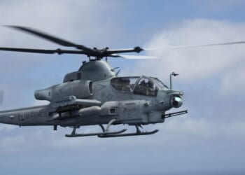 A U.S. Marine Corps AH-64 Apache helicopter flies through the sky on April 29, 2018.