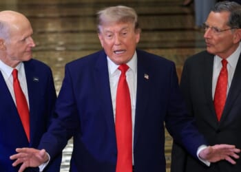 President Donald Trump speaks to the media on Capitol Hill Wednesday, flanked by GOP Sens. Rick Scott of Florida, left, and Senate Majority Whip John Barrasso of Wyoming.
