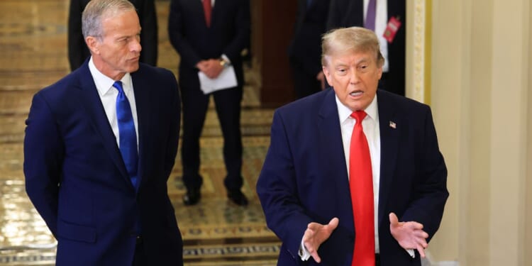 GOP Senate Majority Leader John Thune of South Daokota, left, watches as President Donald Trump speaks to the media Wednesday as they arrive at the U.S. Capitol in Washington, D.C.