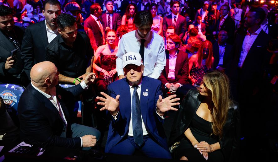 President Donald Trump, center, gestures as he attends UFC Freedom 250 alongside UFC President and CEO Dana White, left, and first lady Melania Trump on the South Lawn of the White House in Washington, Monday, June 15, 2026. (Evan Vucci/Pool Photo via AP)