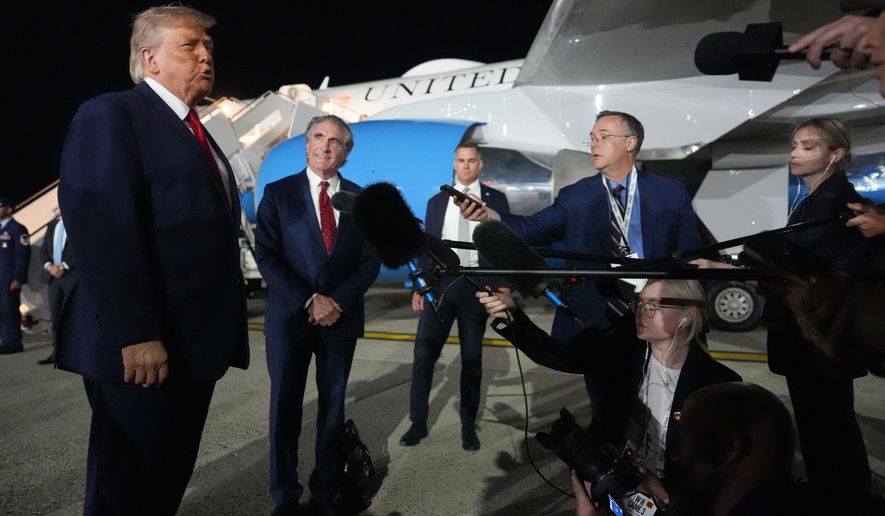 President Donald Trump talks with reporters before boarding Air Force One at John F. Kennedy International Airport in New York, early Tuesday, June 9, 2026. (AP Photo/Mark Schiefelbein)