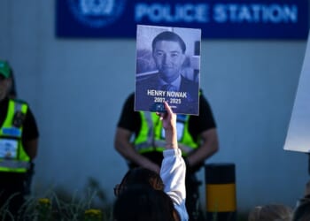 Protesters confront police as one holds up a picture of Henry Nowak at Portswood Police station near where Nowak was killed in Southhampton, England, on June 2, 2026.