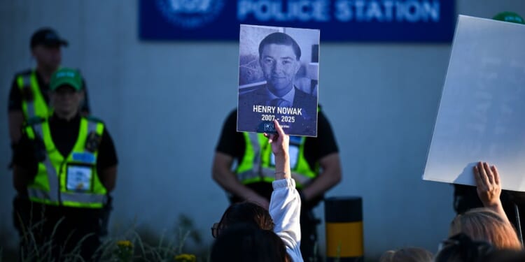 Protesters confront police as one holds up a picture of Henry Nowak at Portswood Police station near where Nowak was killed in Southhampton, England, on June 2, 2026.