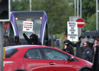 Protesters start to gather, blocking roads in central Belfast, Northern Ireland, in the evening of June 9, 2026. Northern Ireland police said on June 9, 2026 they had arrested a man following what Prime Minister Keir Starmer branded a "sickening" stabbing in Belfast, with graphic video prompting protest calls from UK far-right figures. Video of the June 8, 2026 incident posted on social media networks shows a man straddling another man lying in a street and slashing him several times in the head and neck with a knife in what appears to be an attempted beheading. (Photo by Paul Faith / AFP via Getty Images)