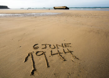 The date 6 June 1944 written in the sand of the beaches of Normandy, France.