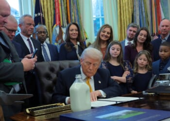 President Donald Trump signs a document during an event with dairy farmers