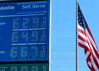 Six-dollar gas is displayed at a California gas station with the American flag in the background.