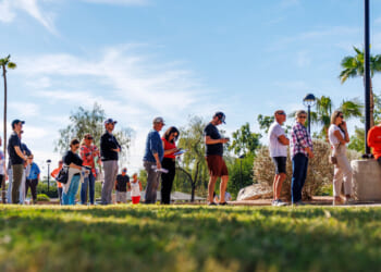 Arizona residents wait in line to vote early at the Indian Bend Wash Visitor Center on October 30, 2024.