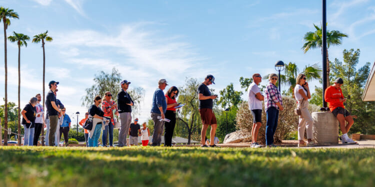 Arizona residents wait in line to vote early at the Indian Bend Wash Visitor Center on October 30, 2024.