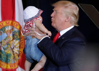 Donald Trump holding a baby