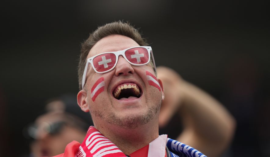 A fan of Switzerland cheers prior to the World Cup Group B soccer match between Switzerland and Bosnia in Inglewood, Calif., near Los Angeles, Thursday, June 18, 2026. (AP Photo/Andre Penner)